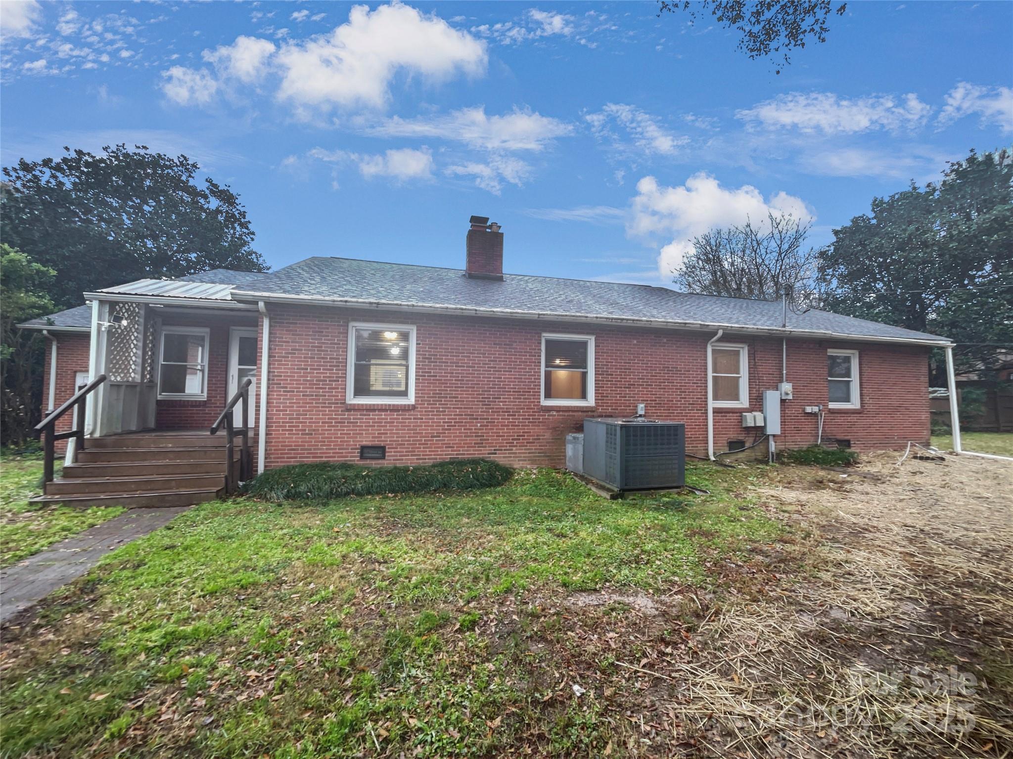 2009 Hickory Grove Road Gastonia, NC 28056 - Photo 5 of 20 a view of a yard in front of a house with large tree