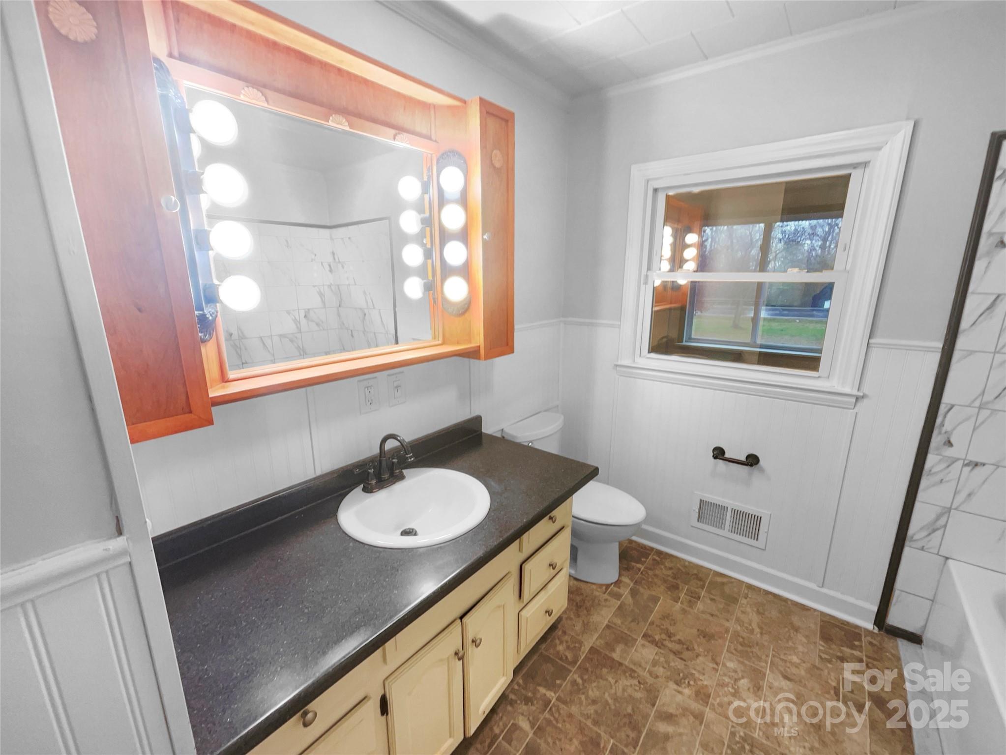 2009 Hickory Grove Road Gastonia, NC 28056 - Photo 6 of 20 a bathroom with a sink a toilet and a mirror