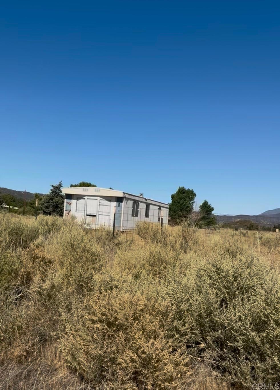 0 Bach Road Anza, CA 92539 - Photo 5 of 8 a view of a large building with a yard in front of it