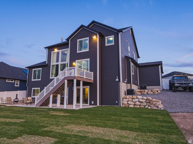 2487 Canyon Wild Road, Unit 413 Draper, UT 84020 - Photo 68 of 75 Back of property at dusk with a patio area and a wooden deck