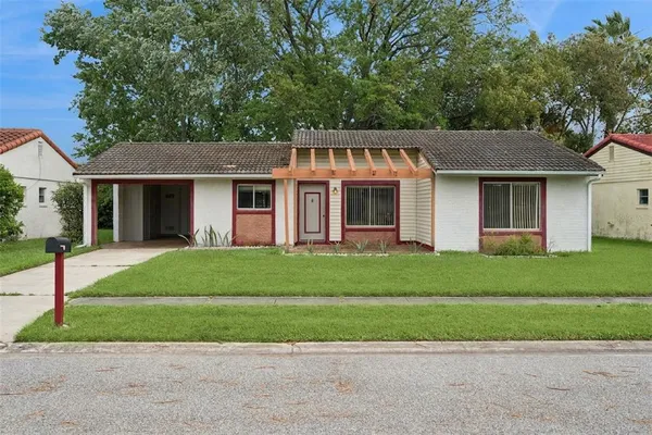 a front view of a house with a garden and plants