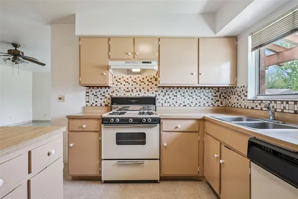 a kitchen with white cabinets sink and white appliances