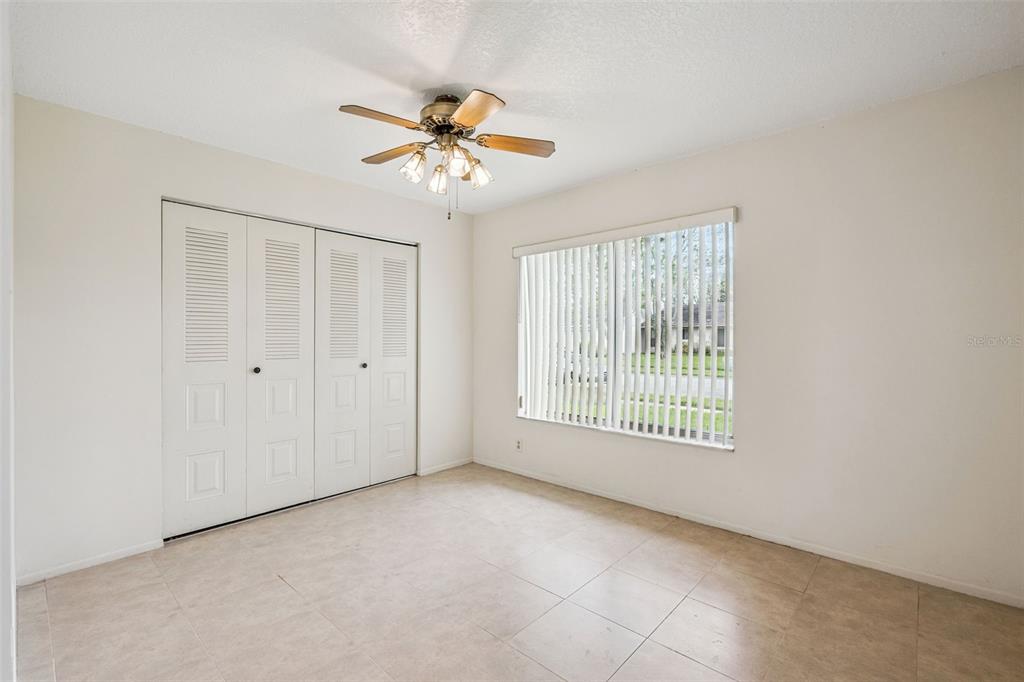10113 Musket Lane Orlando, FL 32821 - Photo 13 of 23 a view of an empty room with a window
