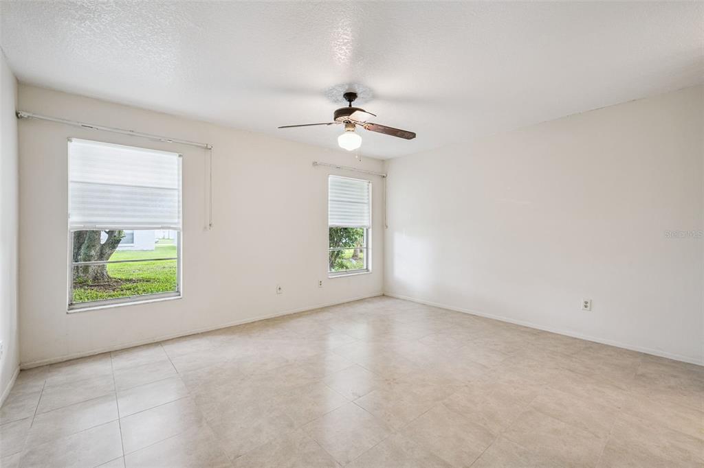 10113 Musket Lane Orlando, FL 32821 - Photo 16 of 23 an empty room with windows and fan