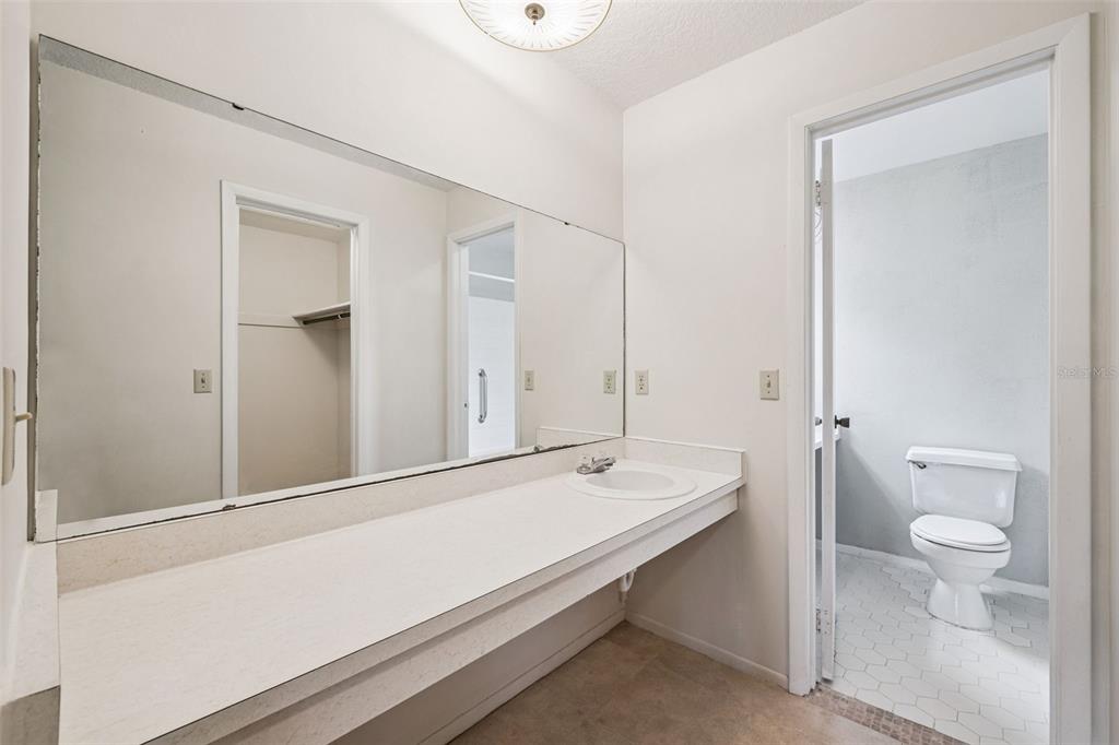 10113 Musket Lane Orlando, FL 32821 - Photo 17 of 23 a bathroom with a sink a toilet and shower