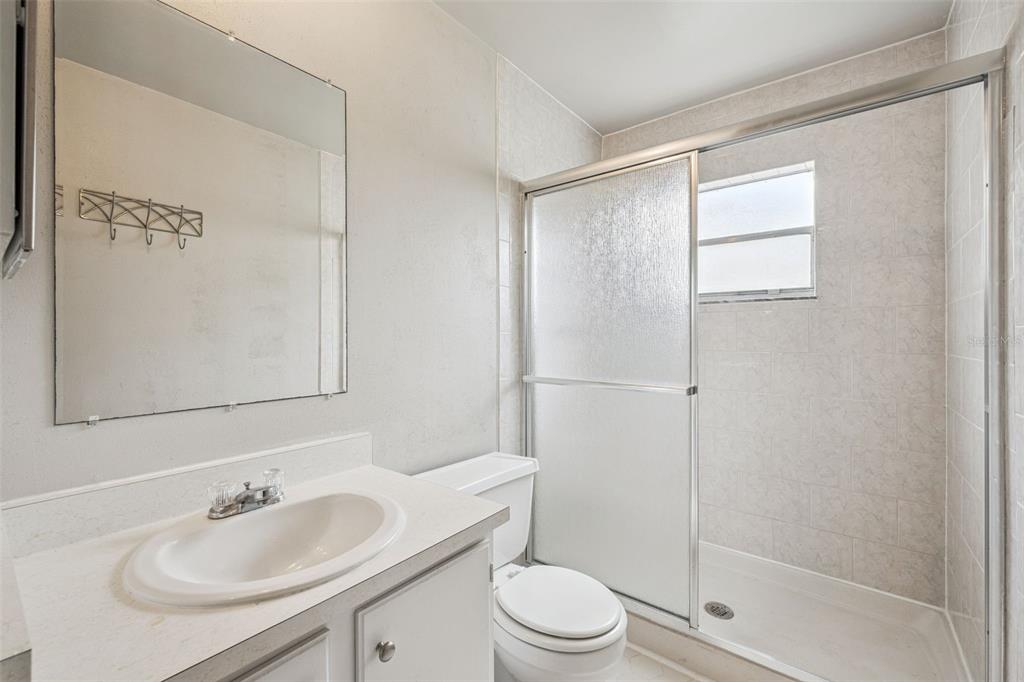 10113 Musket Lane Orlando, FL 32821 - Photo 18 of 23 a bathroom with a sink toilet and shower