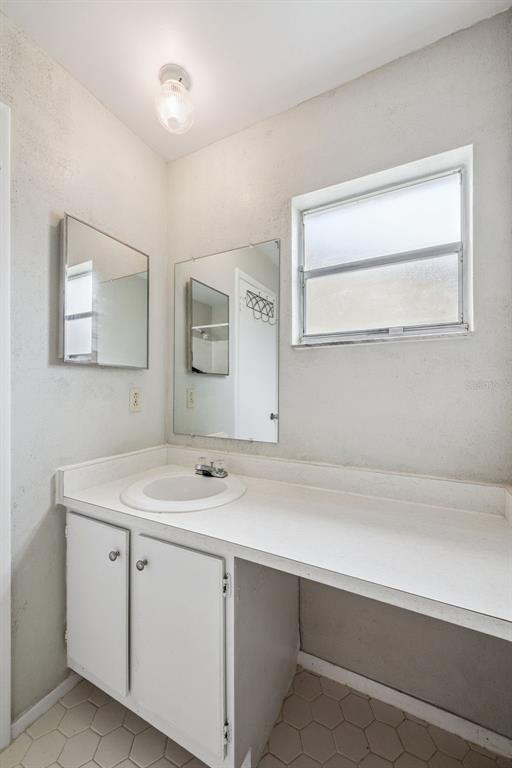 10113 Musket Lane Orlando, FL 32821 - Photo 19 of 23 a bathroom with a sink and a mirror