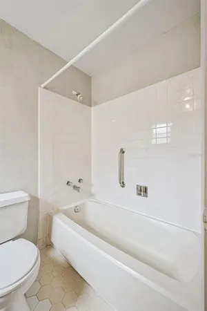 a bathroom with a toilet and a bathtub