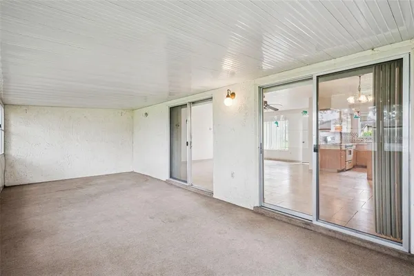 a view of an empty room with glass door