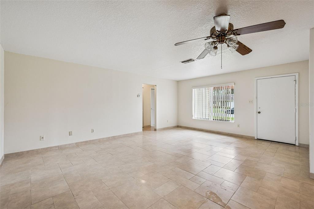 10113 Musket Lane Orlando, FL 32821 - Photo 4 of 23 a view of an empty room with a window