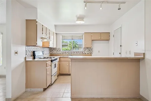 a kitchen with stainless steel appliances a sink stove and cabinets