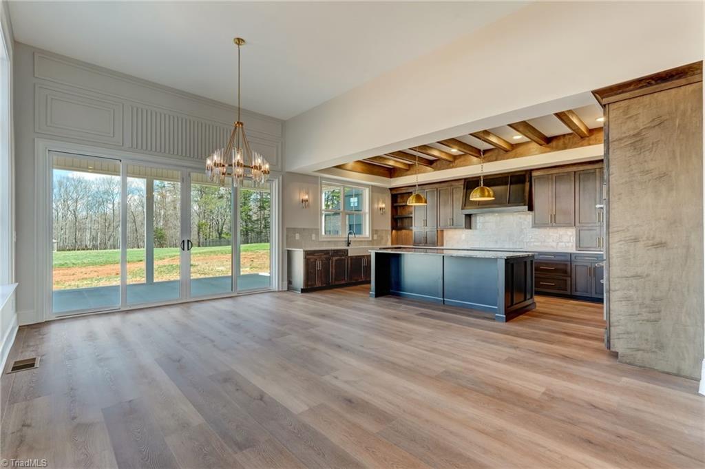 7688 Kyran Court Oak Ridge, NC 27310 - Photo 9 of 40 Looking into Kitchen and dining room from great room.