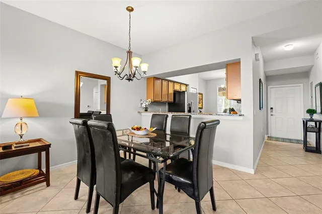 a view of a dining room with furniture and a chandelier