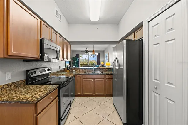 a kitchen with stainless steel appliances granite countertop a refrigerator and a sink