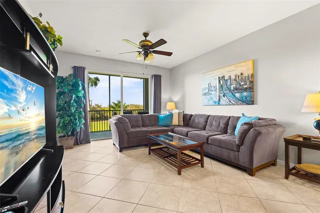 a living room with furniture a dining table and a chandelier