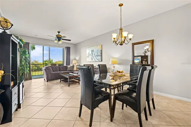 a view of a dining room with furniture and a chandelier
