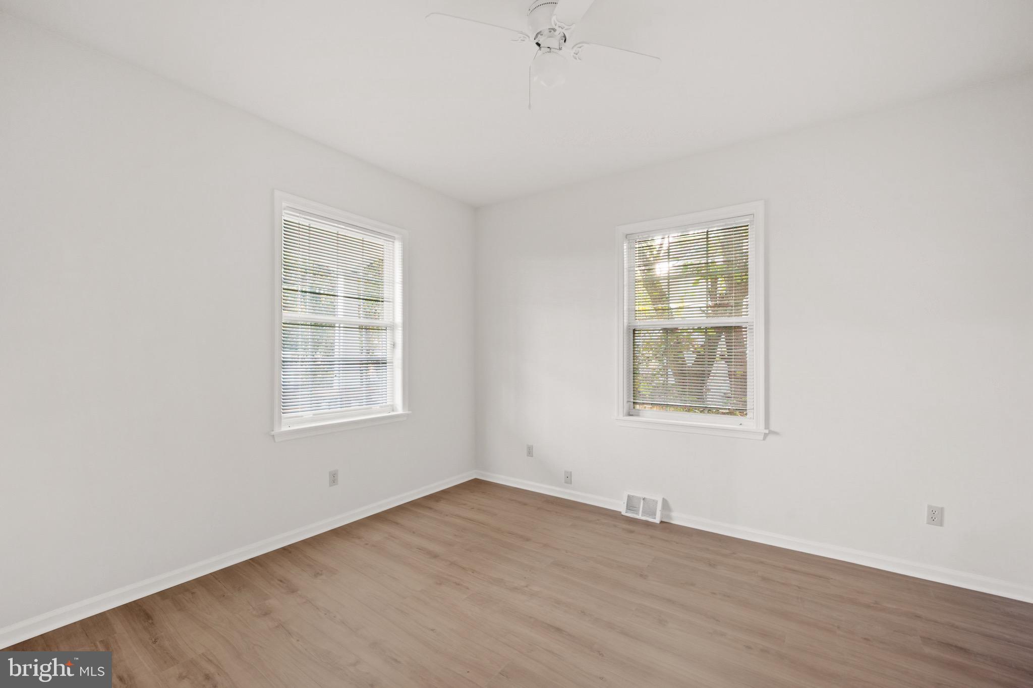 4040 Concord Road Aston, PA 19014 - Photo 12 of 22 an empty room with wooden floor and windows