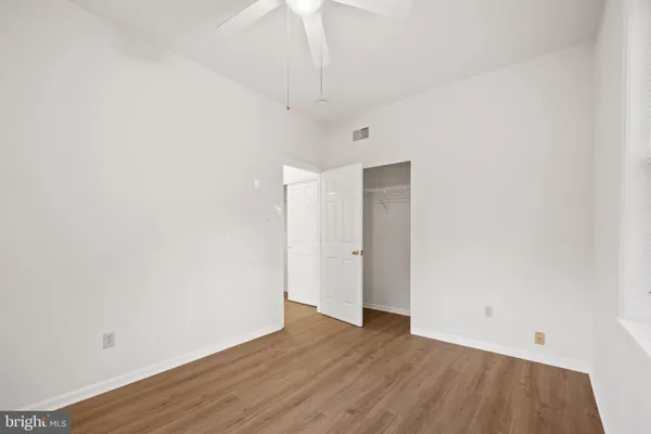 a view of an empty room with wooden floor