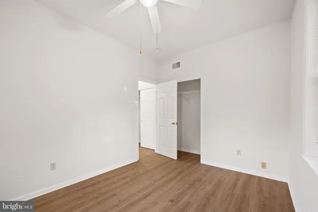 a view of an empty room with wooden floor