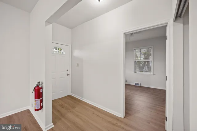 a view of a room with wooden floor and closet
