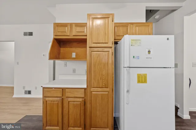a white refrigerator freezer sitting in a kitchen