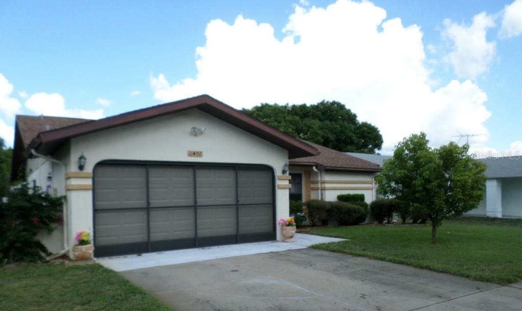 11402 Nature Trail Port Richey, FL 34668 - Photo 1 of 1 a view of a house with a yard