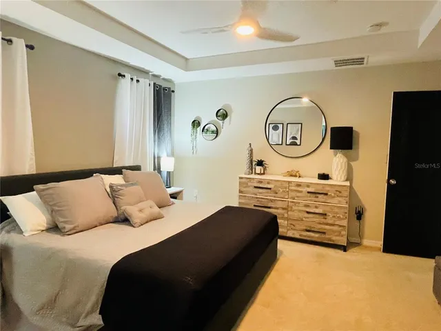 a bedroom with a bed and a chandelier