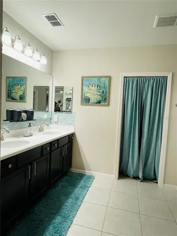 a bathroom with a double vanity sink and a mirror