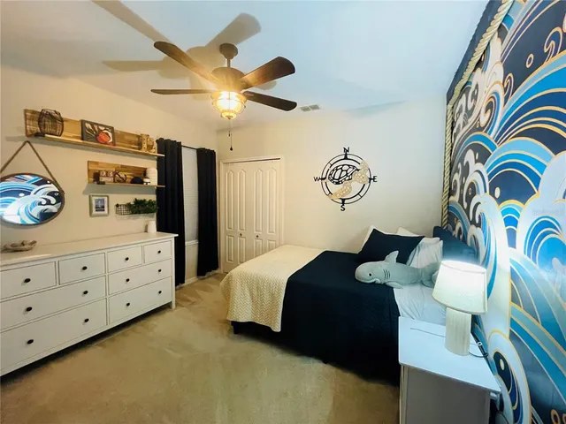 a bedroom with a bed and ceiling fan