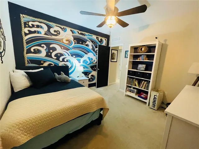 a bedroom with a bed and a book shelf