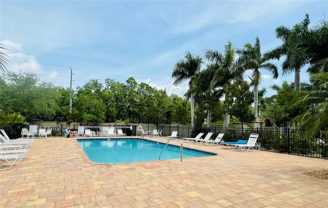 a swimming pool with outdoor seating and yard