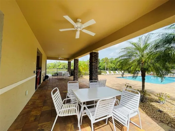 a view of a patio with a table and chairs