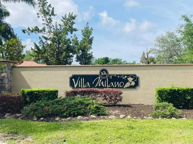 a view of a street sign under a large tree