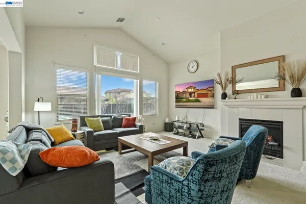 a living room with furniture fireplace and window
