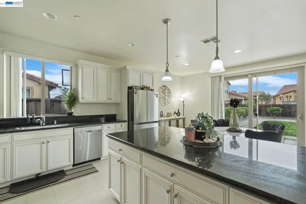 a kitchen with sink and refrigerator