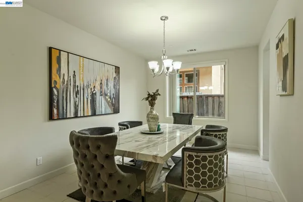 a view of a dining room with furniture and chandelier