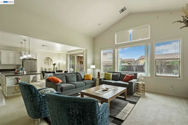 a living room with furniture a rug and a window
