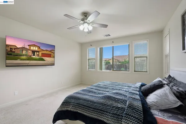 a bedroom with bed and a window