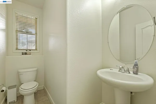 a bathroom with a sink toilet and a mirror