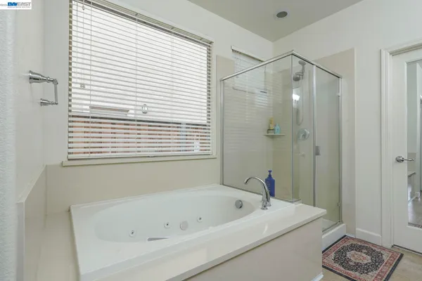 a bathroom with a bathtub and a shower