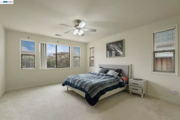 a spacious bedroom with a bed dresser and a window