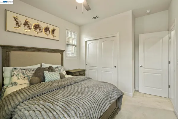 a bedroom with a bed and wall painting