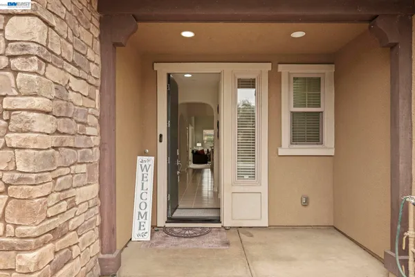 a view of a door house with a door and wooden bench