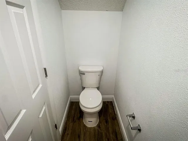 a white toilet sitting in a bathroom