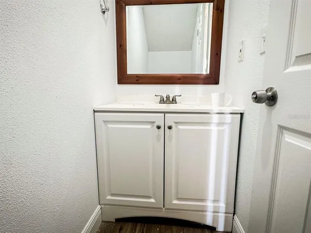 a bathroom with a sink a mirror and vanity