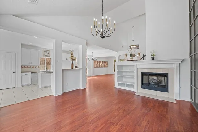 a open kitchen view with fireplace and wooden floor