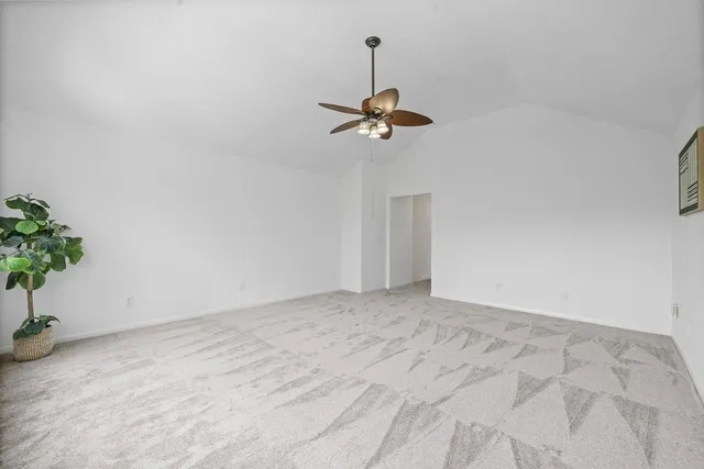 a view of a room with a hanging light and kitchen