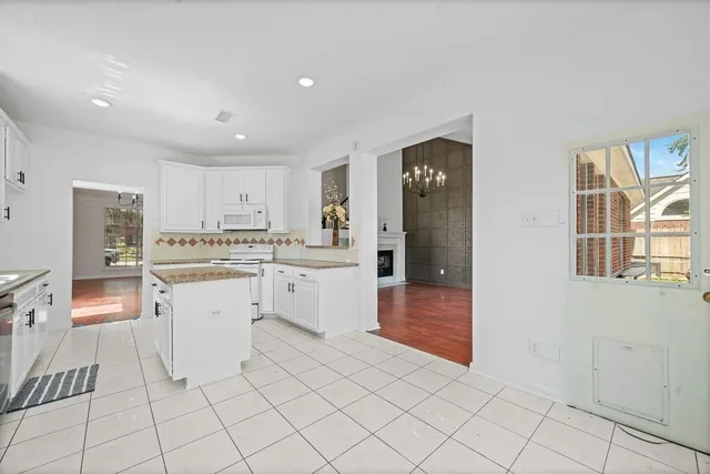 a kitchen with white cabinets and white appliances