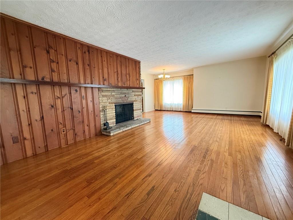123 Hadley Road Greenville, PA 16125 - Photo 23 of 49 a view of empty room with wooden floor and fireplace