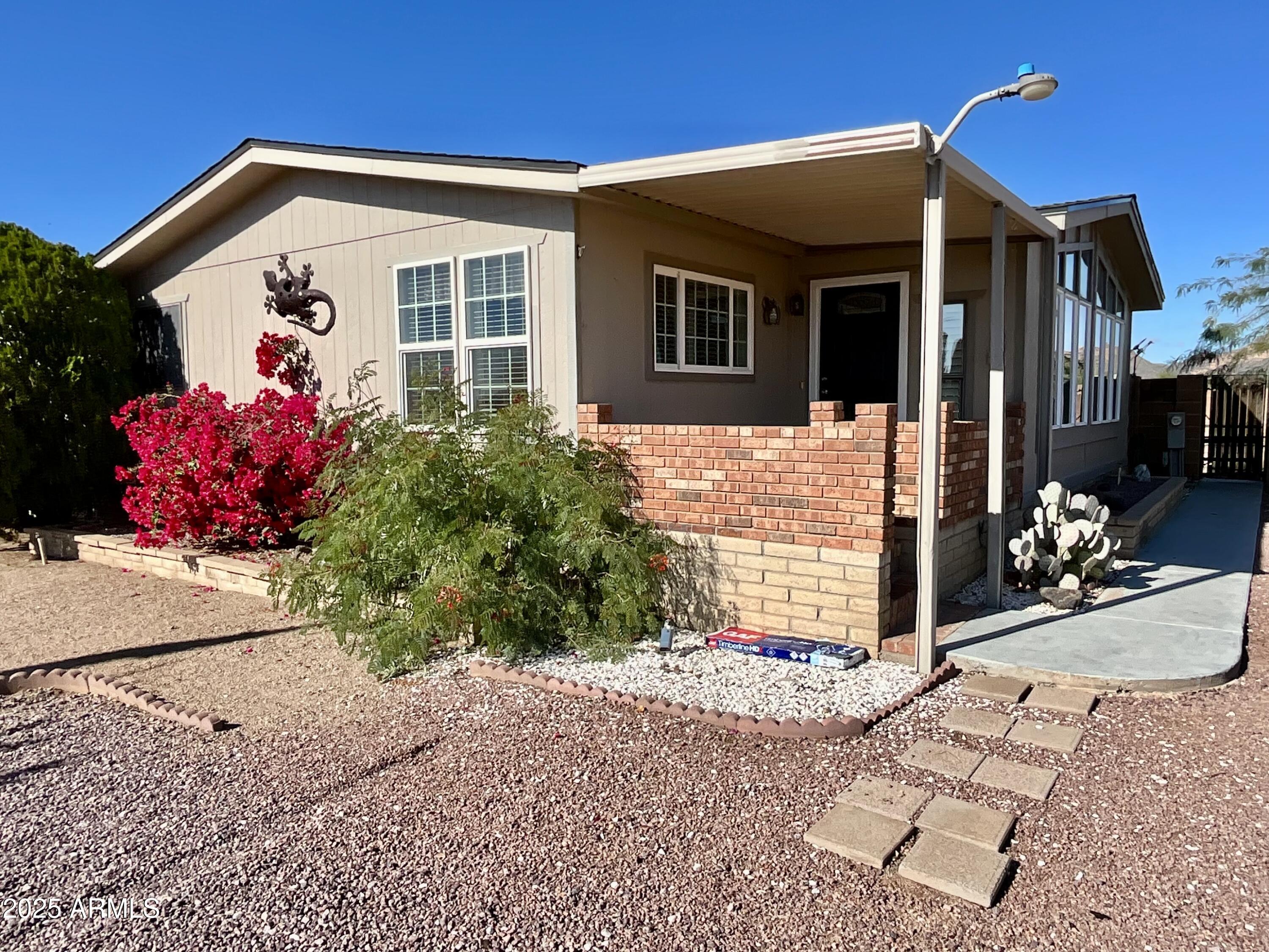 322 West Foothill Street Apache Junction, AZ 85120 - Photo 1 of 33 a front view of a house with a yard